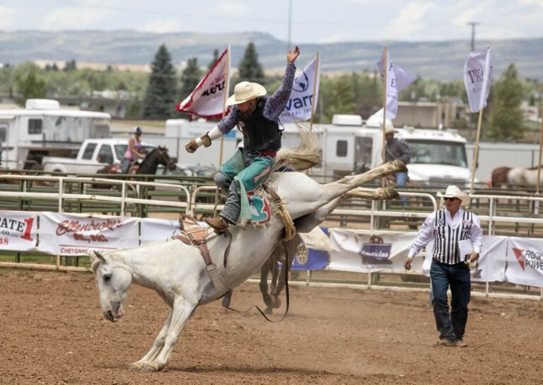 Cowboy Standing on a Bucking Bronco at the Eagle Rodeo